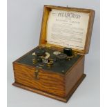 An early 20th century Fellocryst Super crystal radio receiving cabinet, in oak case, the hinged