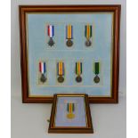 A framed display of medals, comprising a set of three inscribed 47990 Gnr. W. Lupton Royal Field