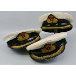 Three Royal Navy captain's peaked caps, Queen's crown with white tops, one marked Gieves Ltd (3)