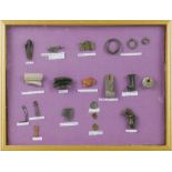 A framed display of metal detector and archaeological Roman finds, including pottery fragments,