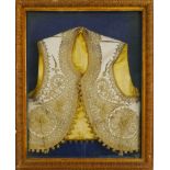 An Indian ivory coloured silk waistcoat, worked with gold thread embroidery with beaded edges,