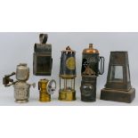 Seven various hand lamps, including miner's brass and steel safety lamp by The Protector Lamp and