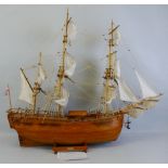 A wooden model of Captain Cook's sailing ship The Endeavour, with teak hull, deck and fittings and