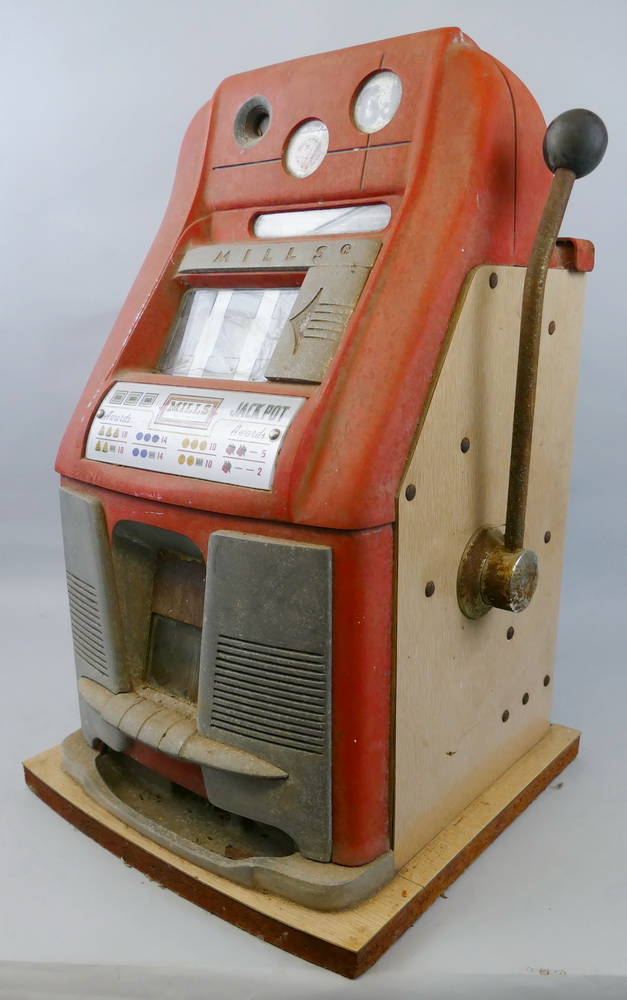 A Mills Bell-o-Matic arcade fruit machine, in aluminium and red painted case with formica type sides