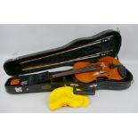 A German violin with 36cm two-piece maple back and pine belly, bears label "Antonius Stradivarius