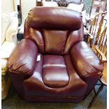 A maroon upholstered electrically operated recliner armchair