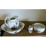 A Victorian four-piece dressing table set, comprising jug and bowl, toothbrush holder and chamber