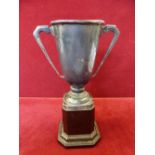 A silver two-handled trophy cup, Birmingham 1939 raised on a pedestal