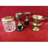 Three silver trophies, various dates and a silver mounted cast hair tidy (4)