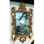 A rectangular wall mirror, with ornate floral scroll frame, height 100cm overall