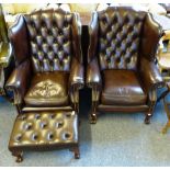 A pair of brown leather upholstered Georgian style wing-back armchairs, with matching deep
