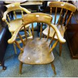 An early 20th century fruitwood, ash and elm smokers bow armchair, a reproduction Victorian style