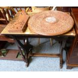 An oak refectory style side table, the end supports carved with anchors and an Eastern carved and