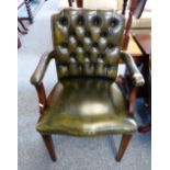 A green leather upholstered office elbow chair with deep buttoned back