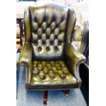 A green leather upholstered Georgian style deep buttoned swivel office armchair