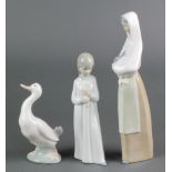 A Nao figure of a lady holding a rabbit 10 1/2", a ditto of a girl in nightwear 8" and another of