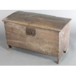 A 17th/18th Century coffer of plank construction with hinged lid, long iron hinges and iron lock