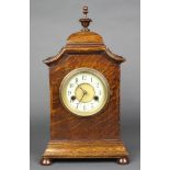 A Hamburg American Clock Co. striking mantel clock with enamelled dial and Arabic numerals contained