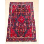 A Persian red and blue ground Brojerd rug 49" x 79"