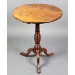 A 19th Century circular elm tea table raised on a turned column and tripod base 28"h x 23"w There is