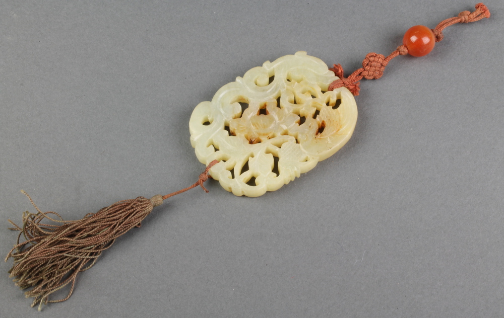 A carved jadeite pendant with scrolls and flowers 2 1/2" x 2"