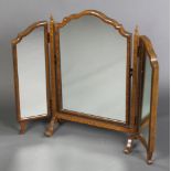A Queen Anne style triple plate dressing table mirror contained in an arched walnut frame 25"h x
