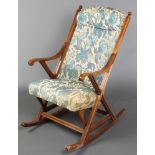 A Victorian mahogany show frame rocking chair with upholstered seat and back