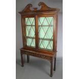 A Georgian mahogany Chippendale style display cabinet on stand, the upper section with broken