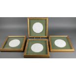 A set of 4 white bisque circular plaques depicting classical figures, framed 5 1/2"
