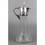 An early 20th Century WMF silver plated mounted ewer with repousse decoration, the splayed glass