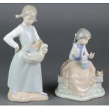 A Nao figure of a girl sitting on a wall beside 2 birds 7" and a ditto of a girl with kittens in her