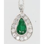 A pear shaped emerald and diamond pendant, the emerald approx 1.5ct surrounded by 14 brilliant cut