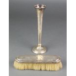 A silver tapered spill vase Birmingham 1972, 8 1/4" and a silver clothes brush The spill vase is