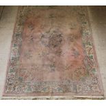 A pink and floral patterned Chinese carpet 147" x 108"