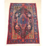 A Persian blue ground Toyserkan rug with central medallion 85" x 55"