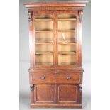 A Victorian mahogany secretaire bookcase, the upper section with moulded cornice, fitted