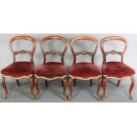 A set of 4 Victorian mahogany balloon back dining chairs with carved shaped mid rails, the seats