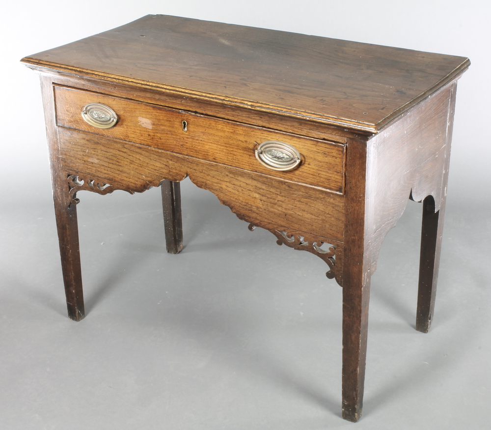 A Georgian oak side table fitted a drawer with pierced and shaped apron raised on pillar supports