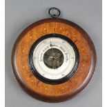 An aneroid barometer with silvered dial contained in an inlaid mahogany case