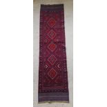 A contemporary red and blue ground Meshwani runner with 5 diamonds to the centre 99" x 25"