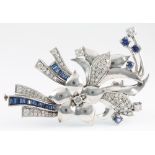 A white gold diamond and sapphire floral spray brooch comprising 33 tapered baguette cut sapphires