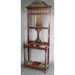 A Victorian walnut hall stand, the back fitted a rectangular plate mirror and 6 hooks, the base