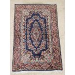 A blue and floral ground Persian Kirman rug 64" x 40"