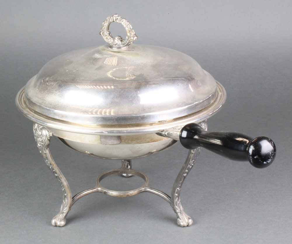 A silver plated food warmer and cover with ebony handle on stand The burner is missing