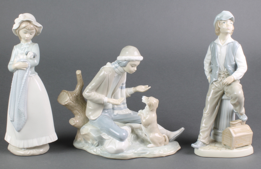 A nao figure of a girl with puppy 10", a ditto of a boy with dog 9" and another of a seated young