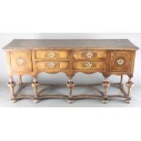 A Queen Anne style figured walnut dresser base, the crossbanded top fitted 4 short drawers flanked