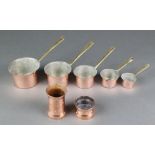 5 Italian copper measures with brass handles 8ozs, 6 ozs, 4 ozs, 2 ozs, 1 ozs, together with 2 brass