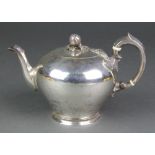 A mid Victorian silver melon shaped teapot with fruit finial and scroll handle with ivory resistors,