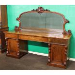 A Victorian mahogany pedestal sideboard with arch shaped mirrored back, the base fitted 1 long