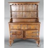 A 17th Century style oak dresser of small proportions, the raised back with shaped and moulded